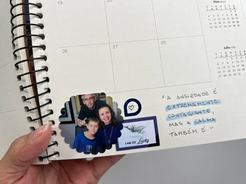 Planner 2026 aberto com frase inspiradora escrita à mão e detalhes em marca-texto colorido.
